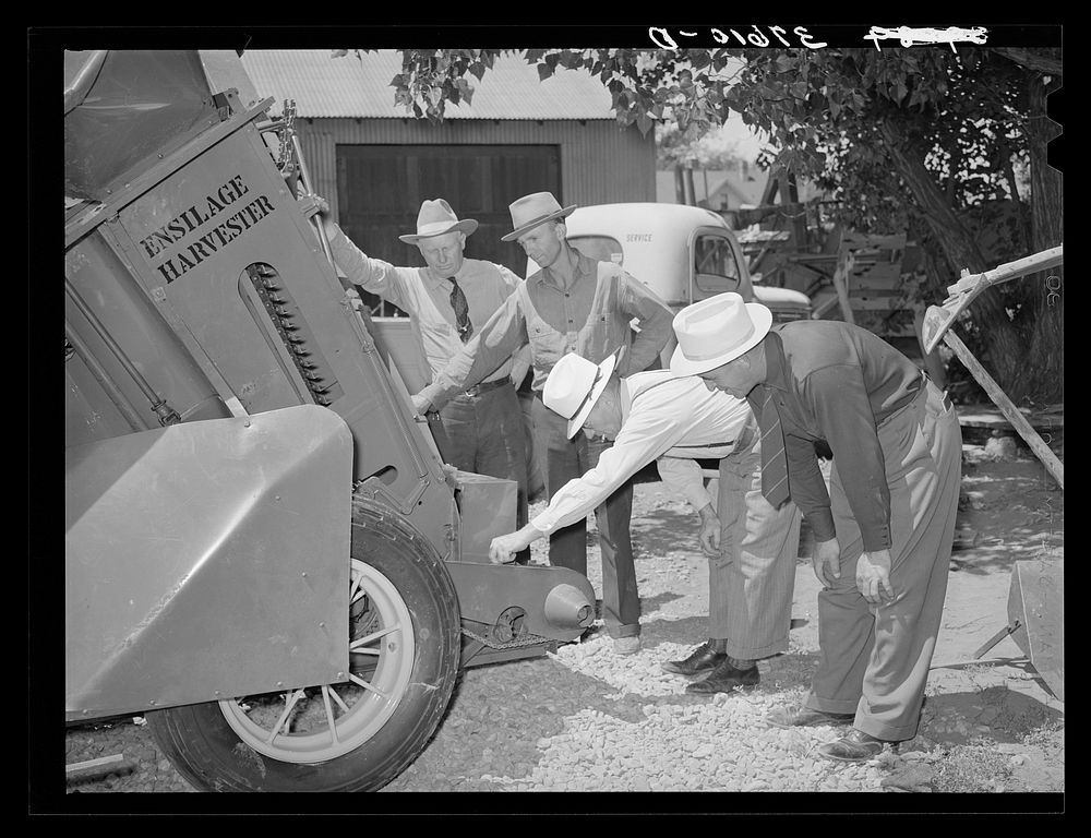 Committee of Cornish, Utah,  corn machinery cooperative looking over ensilage harvester. Preston, Idaho by Russell Lee