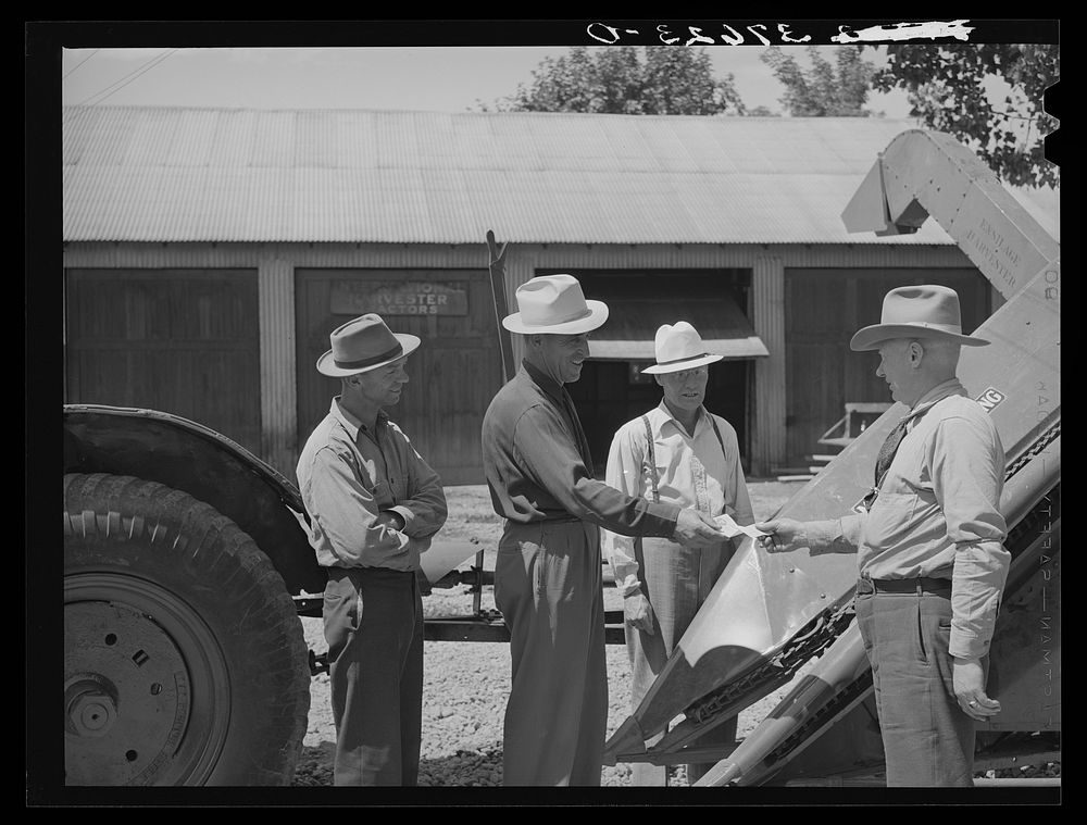 [Untitled photo, possibly related to: Chairman of Cornish machinery cooperative handing over check to dealer in payment of…
