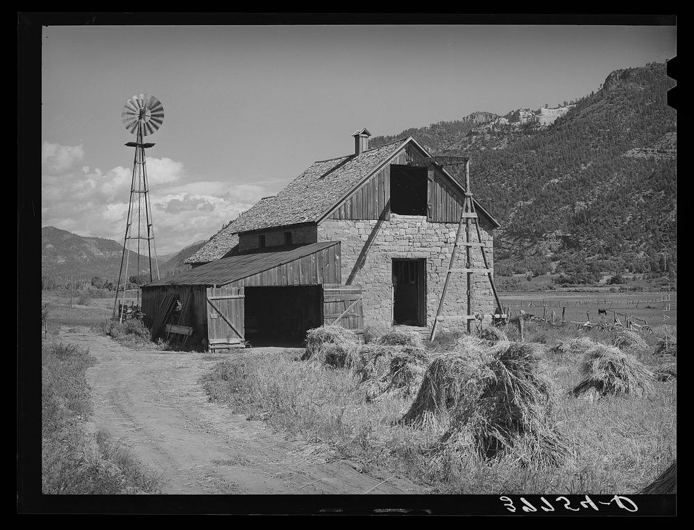 Oats and stone barn on farm in Animas River Valley in La Plata County, Colorado by Russell Lee