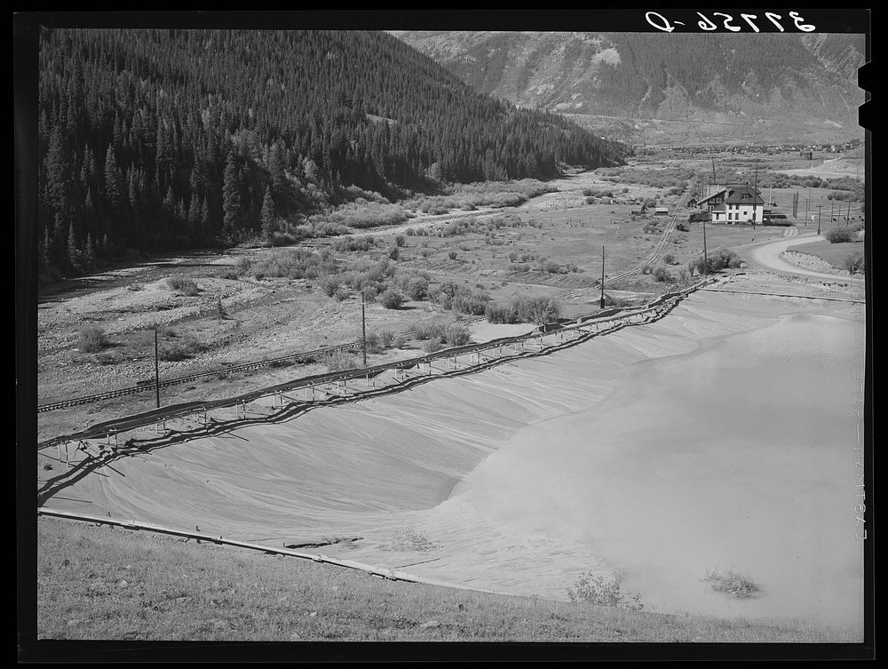 Tailing pit of active gold mine in the valley of the Animas River, San Juan County, Colorado. Ranchers and farmers who want…