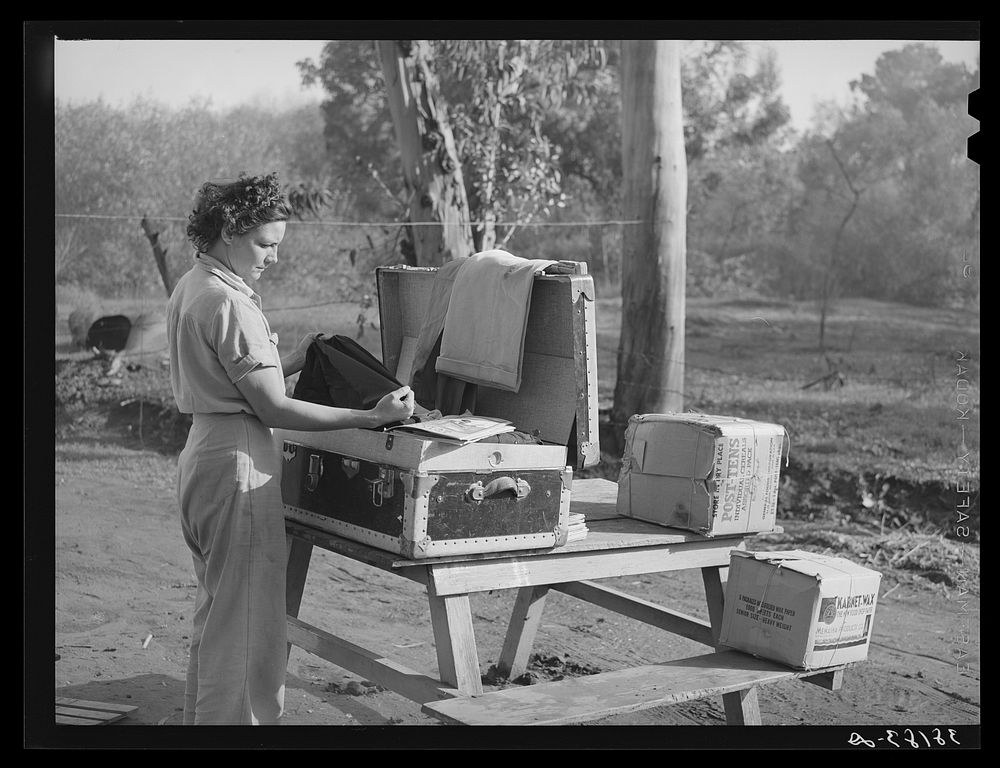 Carpenter's wife unpacking a trunk. Mission Valley, California, which is about three miles from San Diego by Russell Lee