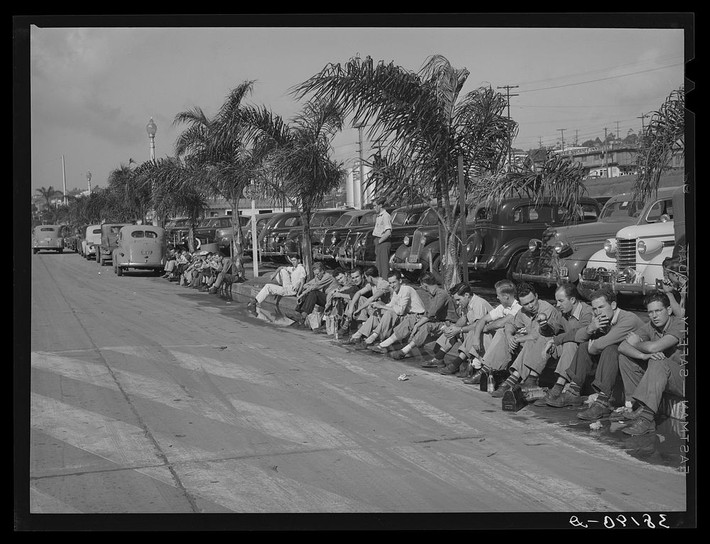Workmen during lunch period, across the street from the Consolidated Airplane Factory. San Diego, California by Russell Lee