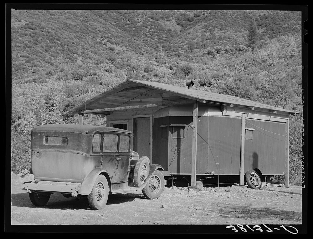 Home of construction worker at Shasta Dam. Summit City, California. Notice that the trailer has been incorporated into the…