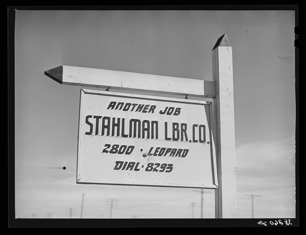 Lumber company sign. Corpus Christi, Texas. Naturally all forms of construction work are on the increase in the town by…