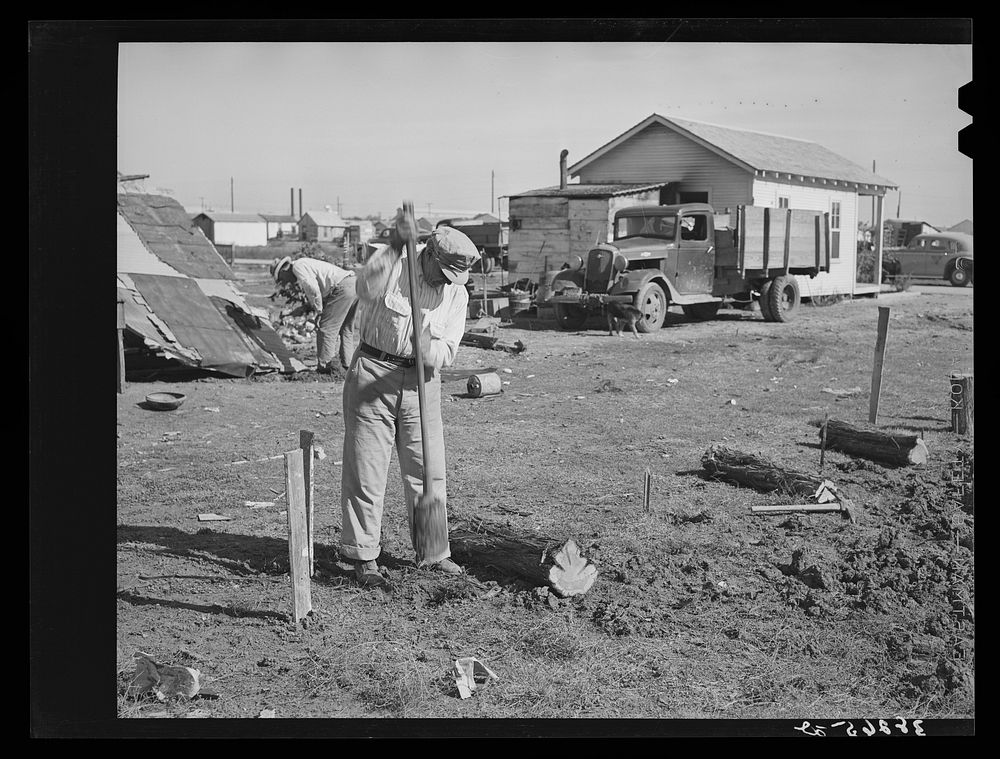 Man working on foundation for new house in cheap residential section of Corpus Christi, Texas. Many cheap houses are now…