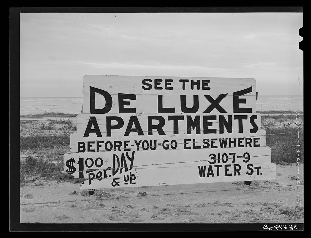 Sign--Deluxe apartments for rent--about three miles from naval air base now under construction. Corpus Christi, Texas. These…