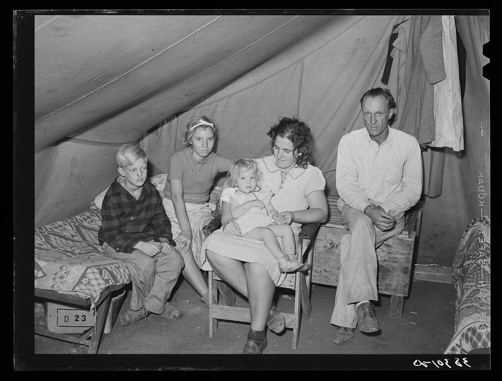 Family of roofer from Oklahoma in their tent home at Corpus Christi, Texas. He is working at the naval air training base. He…