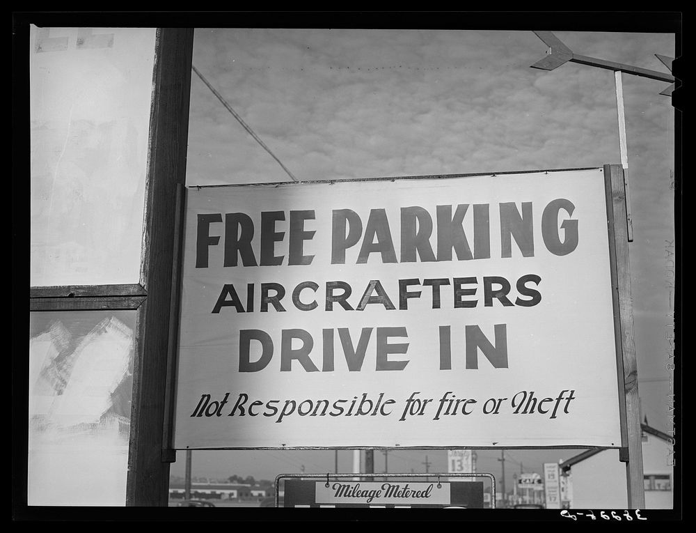 Sign of free parking to aircraft employees. San Diego, California. The parking problems near these defense industries has…