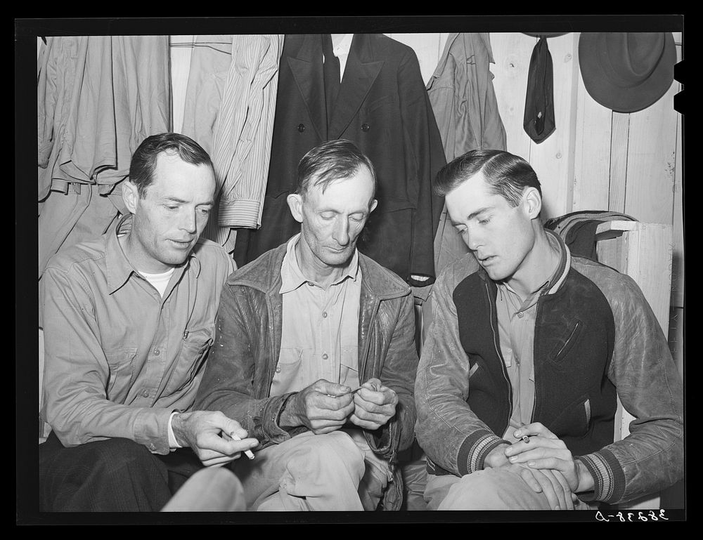 Three men workers at naval air base from Louisiana. These men are living in a tourist court and had to leave their families…