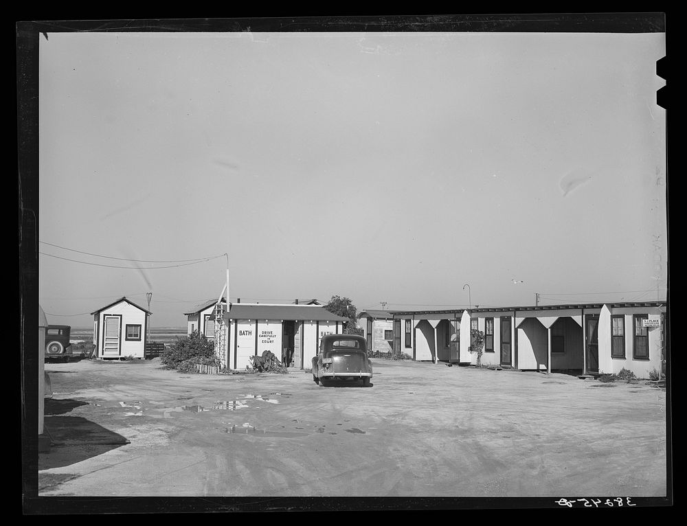 Tourist court showing the sanitary facilities building. Corpus Christi, Texas. These tourist courts are now filled with…