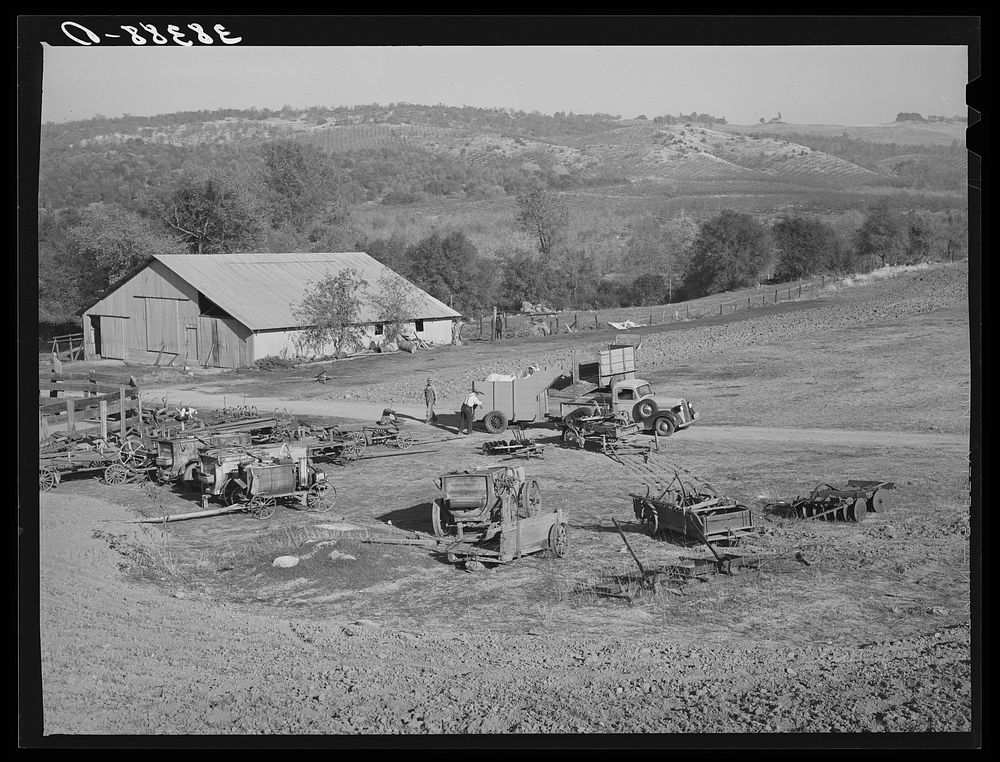 Barn and farm equipment of fruit farmer. Placer County, California. Notice the spraying carts by Russell Lee