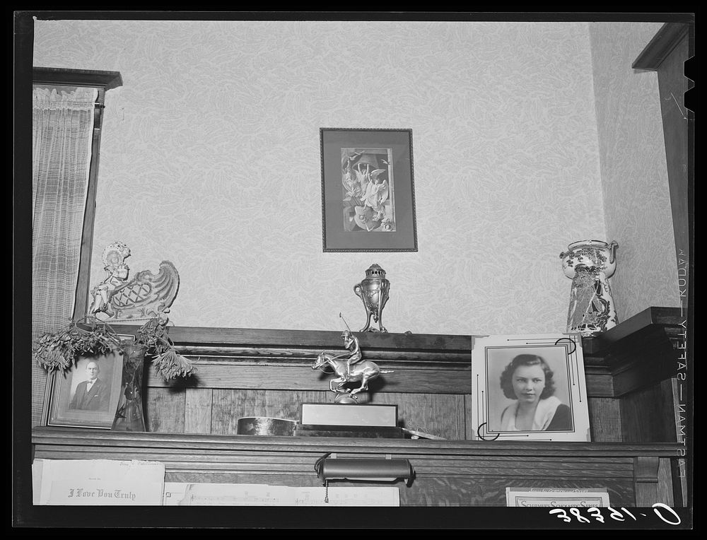 Ornaments on top of piano in living room of fruit farmer. Placer County, California. These farmers have had a very high…