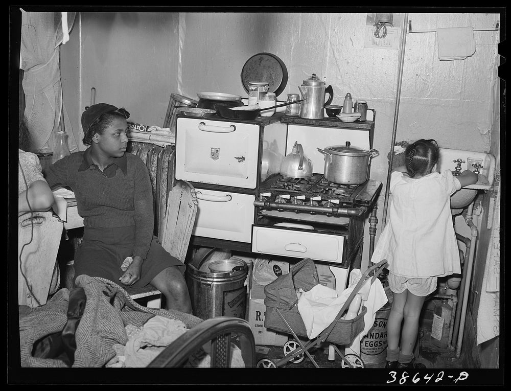 Kitchen in crowded  apartment. Chicago, Illinois by Russell Lee