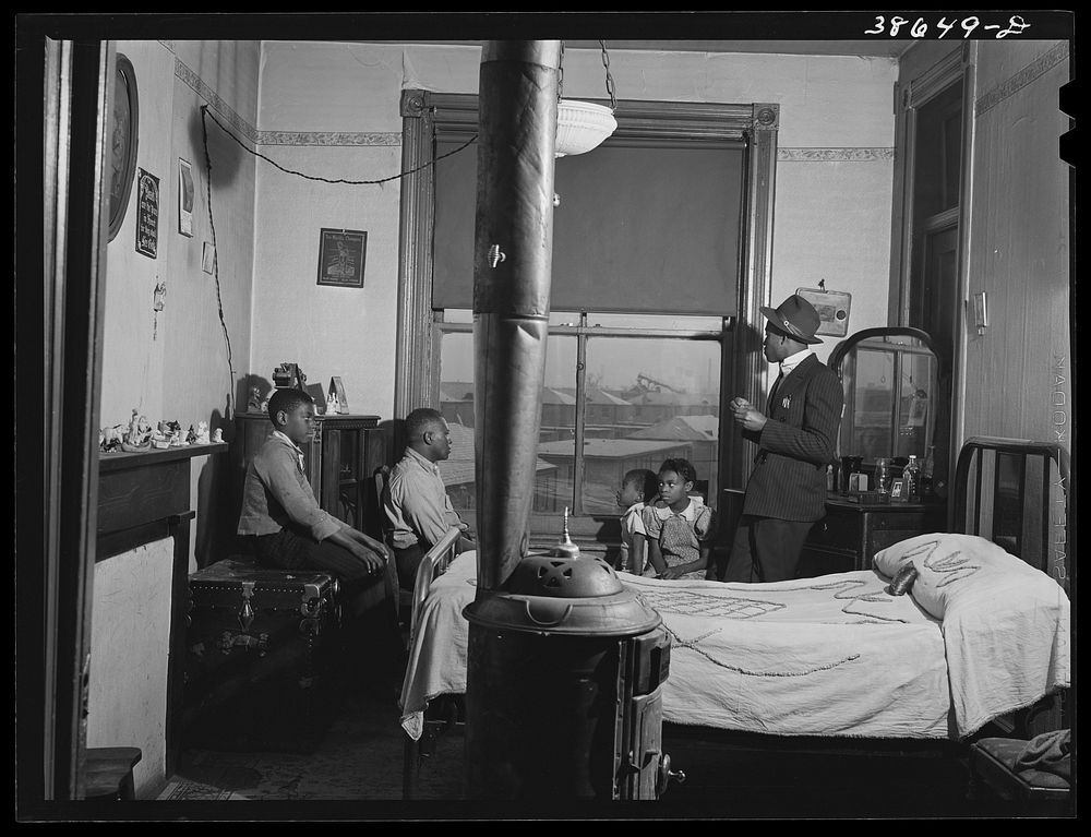 [Untitled photo, possibly related to: Front room of apartment rented by es. Ida B. Wells Housing Project can be seen through…