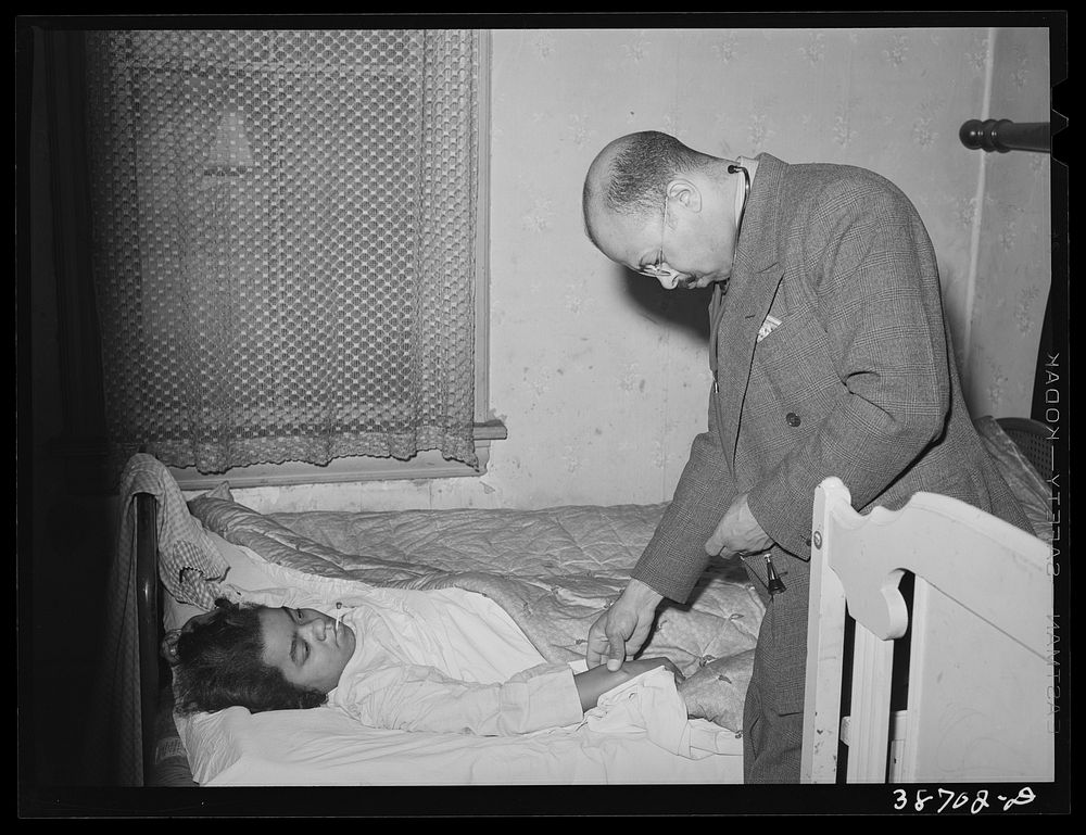 Doctor examining patient in her home. Family is on relief. Chicago, Illinois by Russell Lee