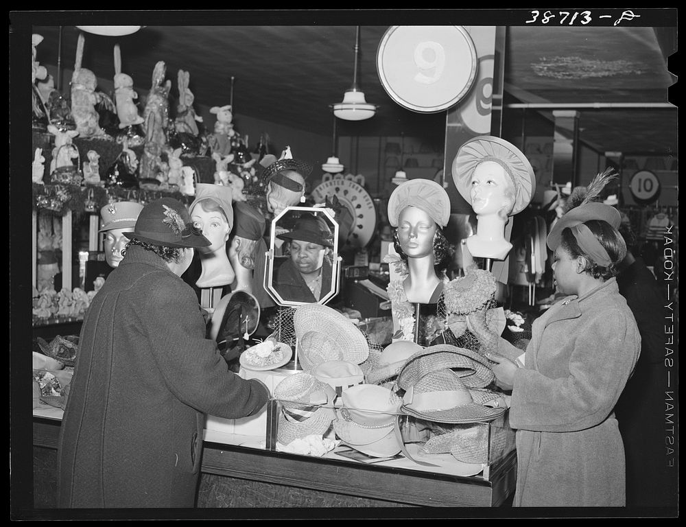 Buying hats in ten-cent store which caters to African Americans. Chicago, Illinois by Russell Lee