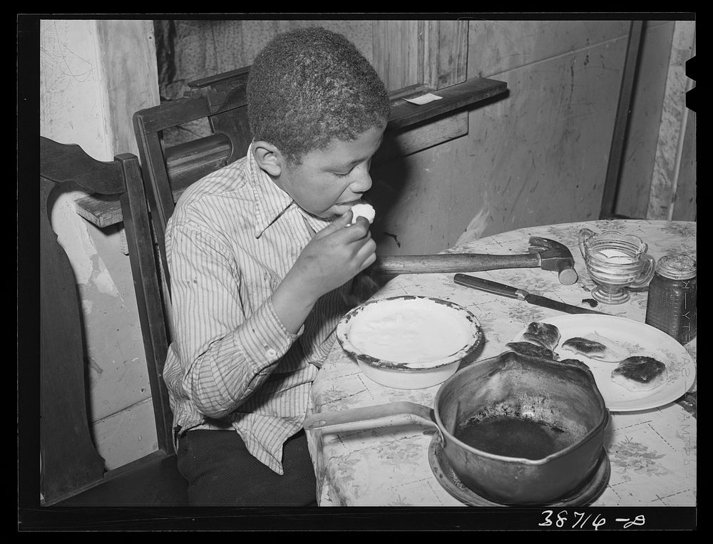 Boy eating. Chicago, Illinois by Russell Lee