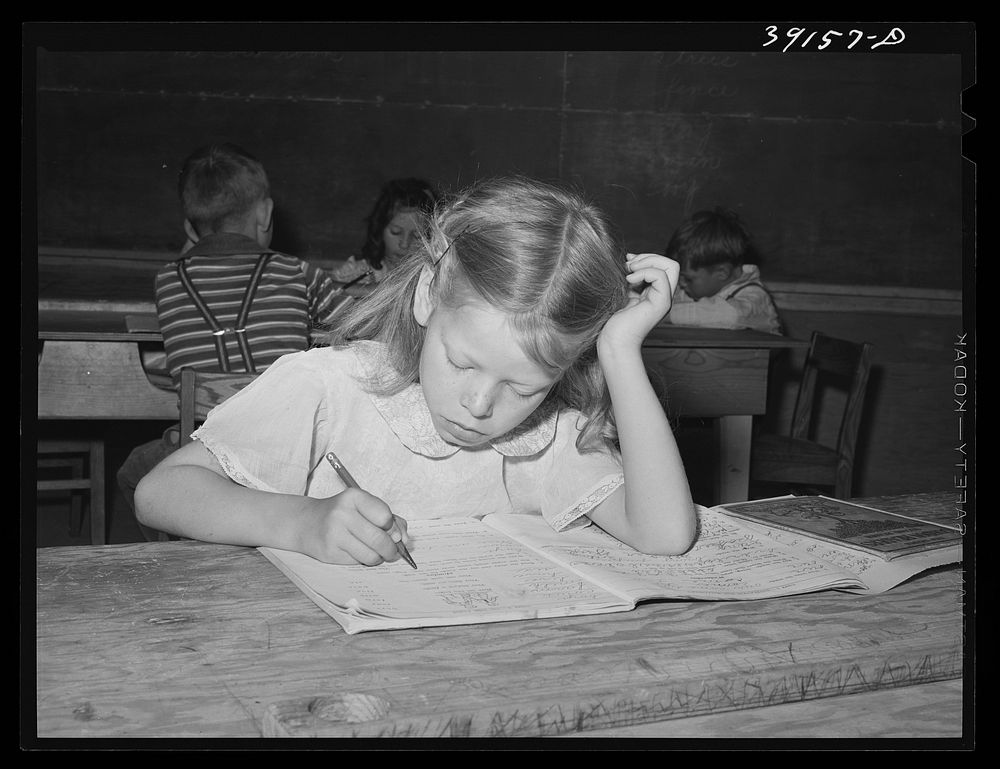 Schoolgirl at the FSA (Farm Security Administration) farm workers' camp. Caldwell, Idaho. Several family units of the row…
