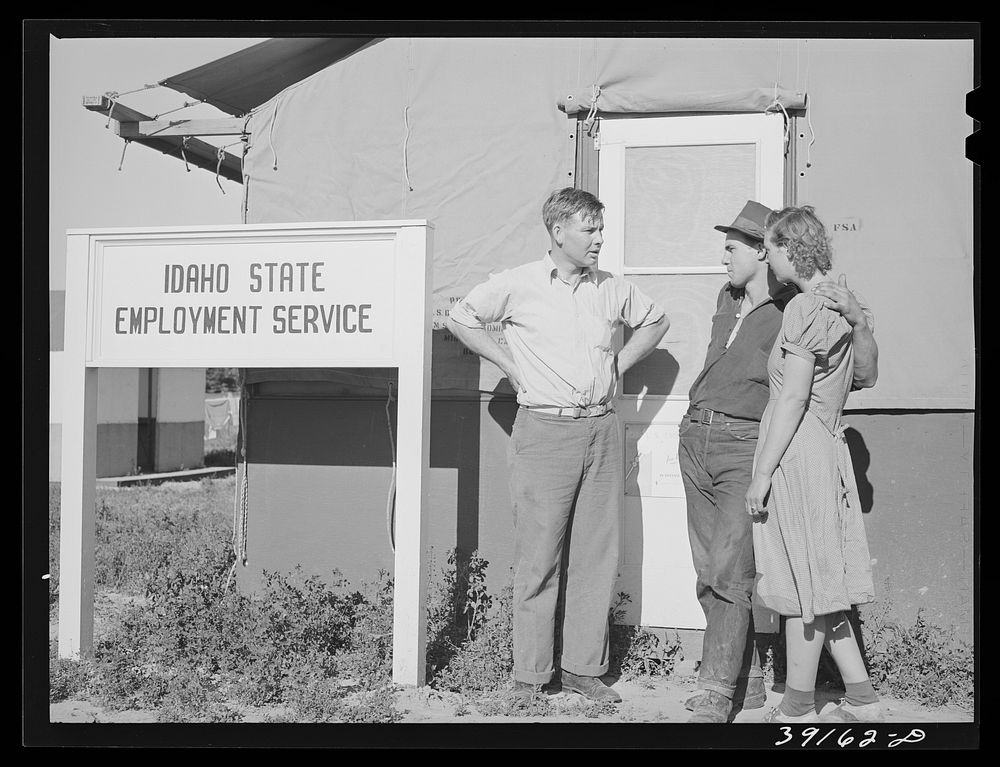 Farm worker and his wife discussing chances of employment with the Idaho state employment representative at the FSA (Farm…