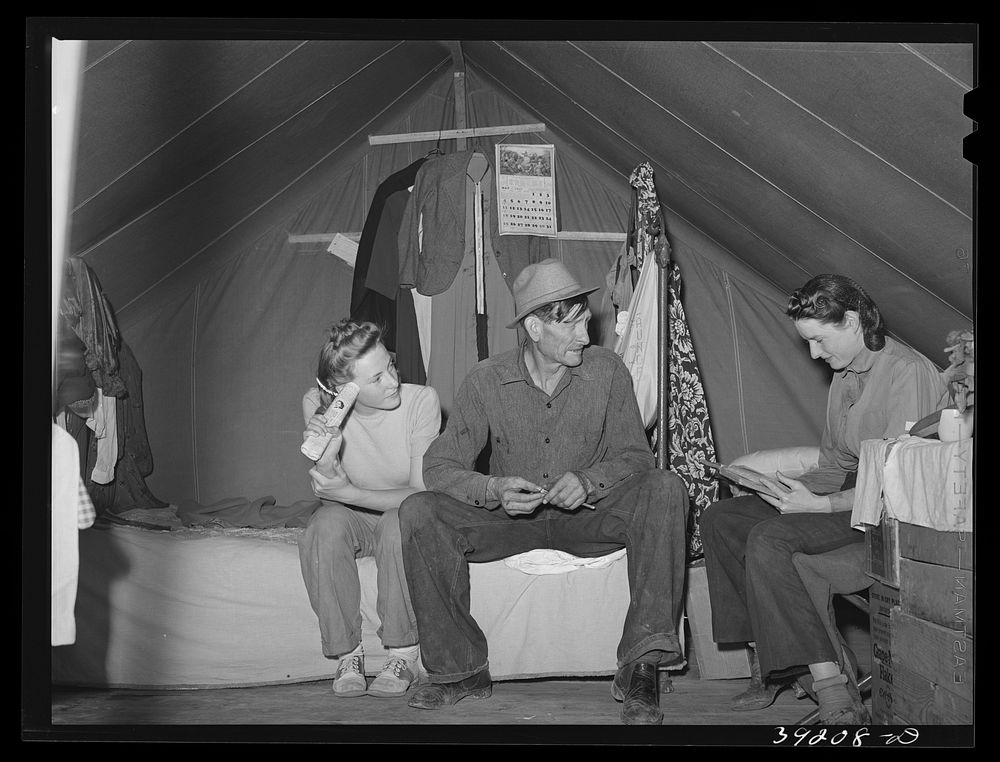 Farm worker and his two daughters in the tent in which they live at the FSA (Farm Security Administration) migratory labor…