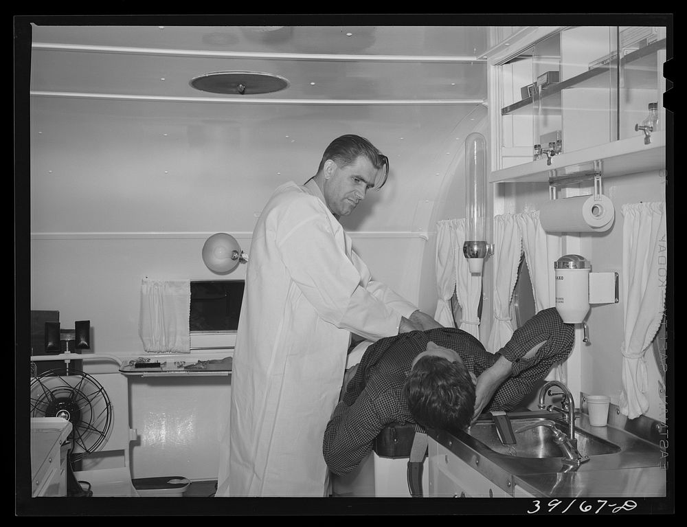 [Untitled photo, possibly related to: Examination in trailer-clinic at the FSA (Farm Security Administration) migratory…