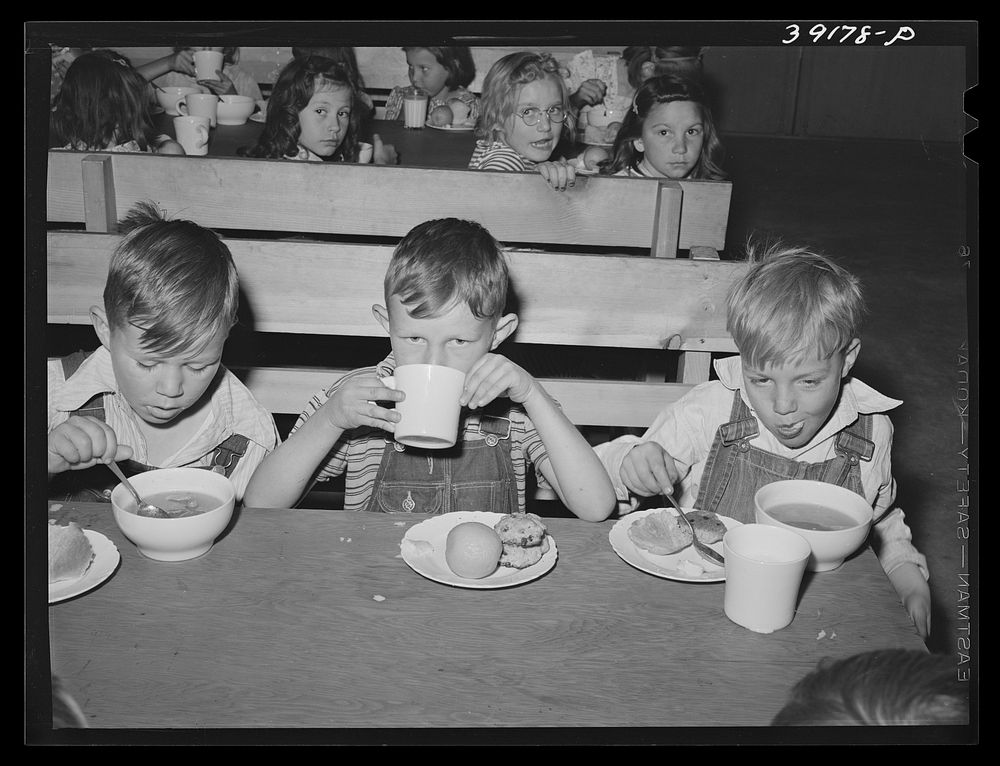 Schoolchildren having lunch at the FSA (Farm Security Administration) farm workers' camp. Caldwell, Idaho by Russell Lee