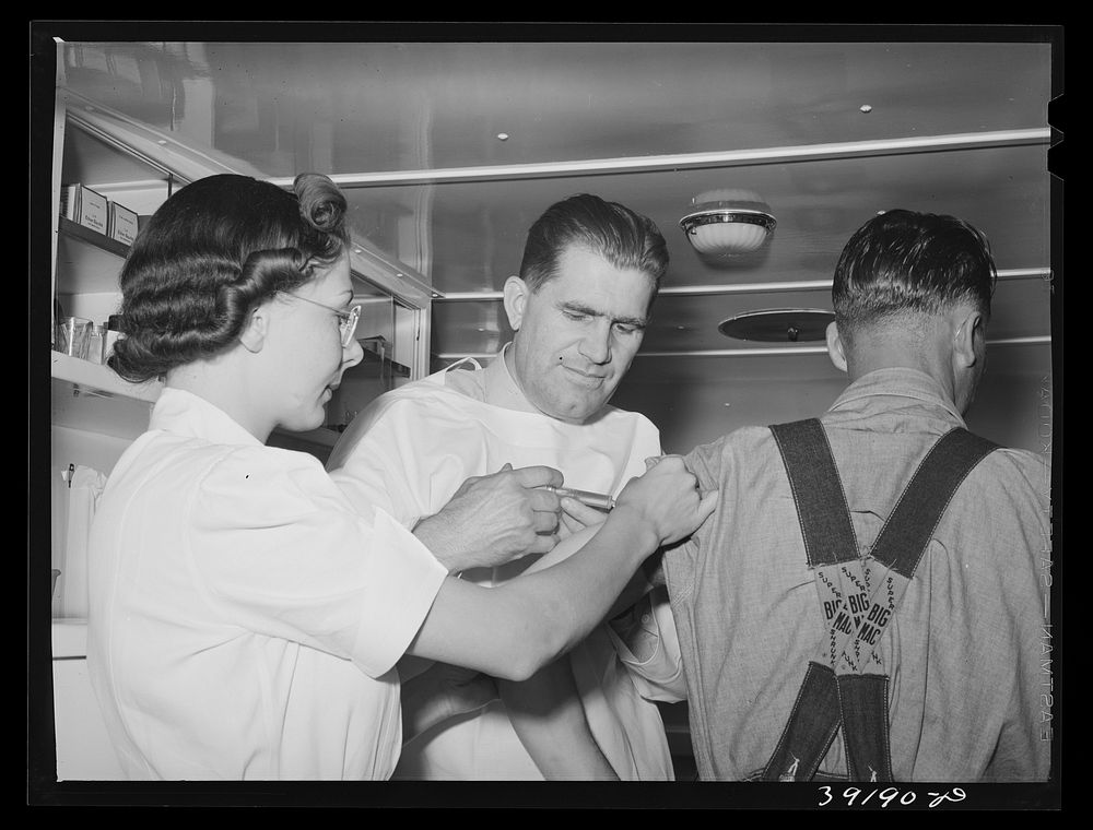 Doctor and nurse and farm worker (patient) at the trailer clinic at the FSA (Farm Security Administration) migratory labor…