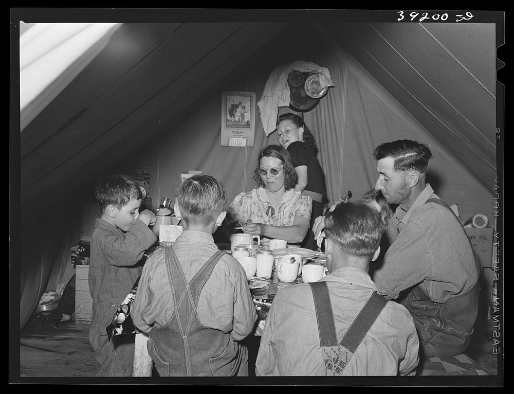 Farm worker's family eating dinner in the tent in which they live at the FSA (Farm Security Administration) migratory labor…