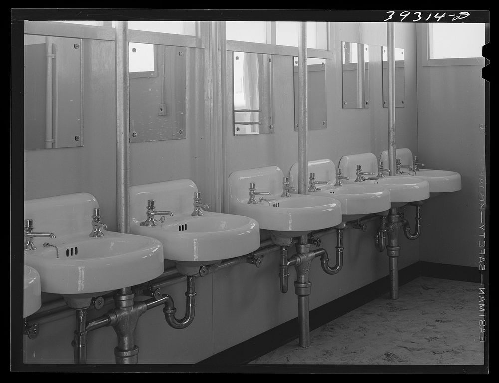 Washbasins at the FSA (Farm Security Administration) trailer camp for defense workers. San Diego, California by Russell Lee