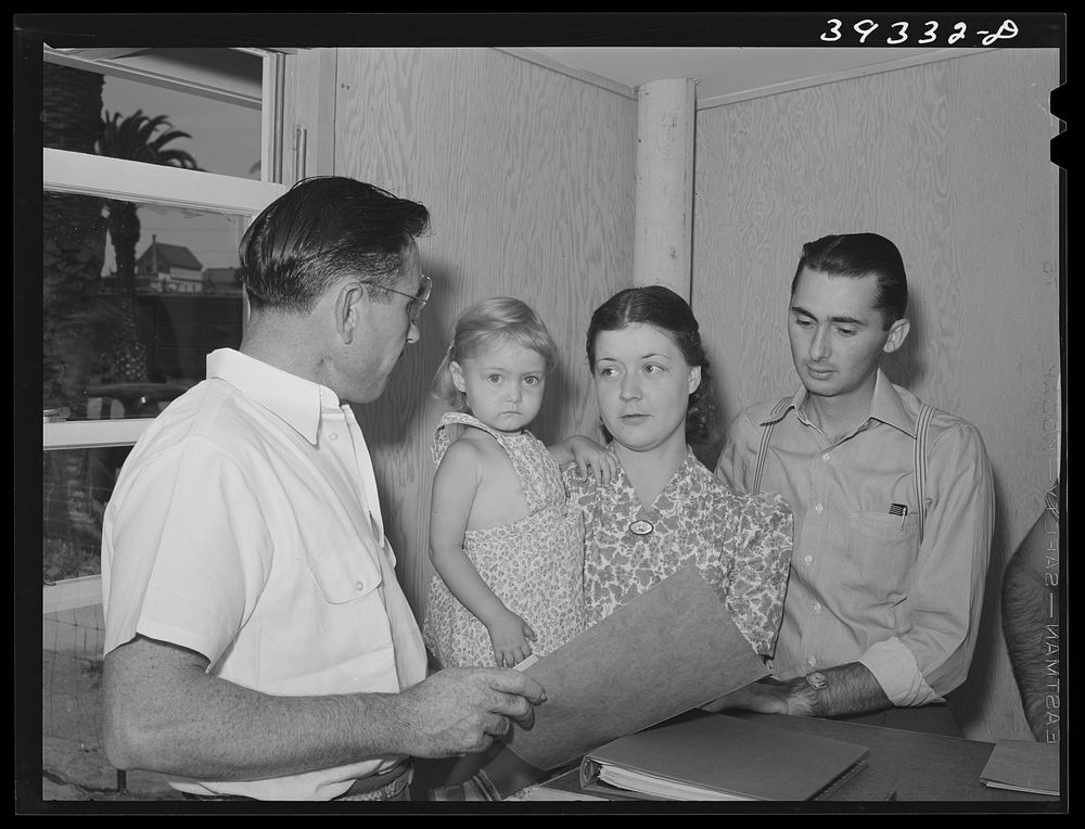 People requesting information and registering at the office of the FSA (Farm Security Administration) trailer camp for…