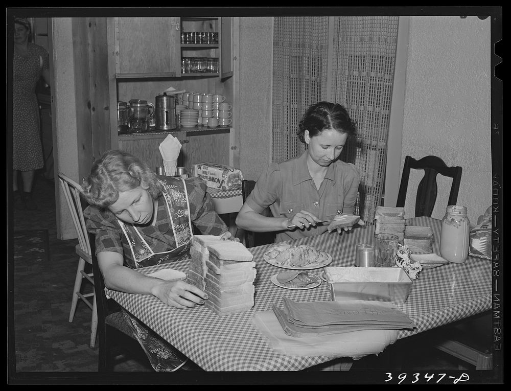 Maids making sandwiches for night shift workmen at Consolidated Aircrafts. This is in a boarding house for single men. They…