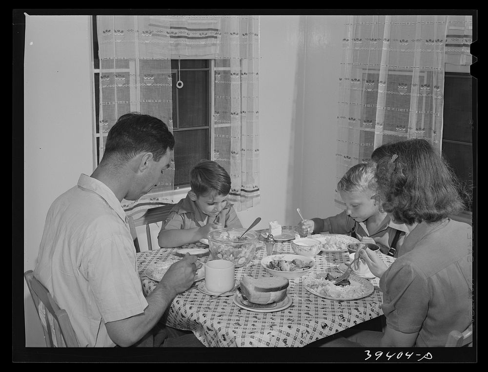 Marine sergeant and his family in the dining room of his home at the Navy defense housing for Navy and Mareines and some…