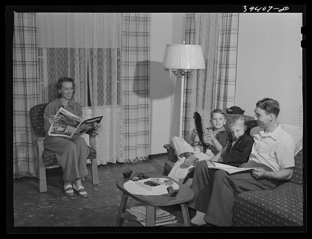 Family of Marine in their living room. They live in one of the units of the Navy defense housing project which is designed…