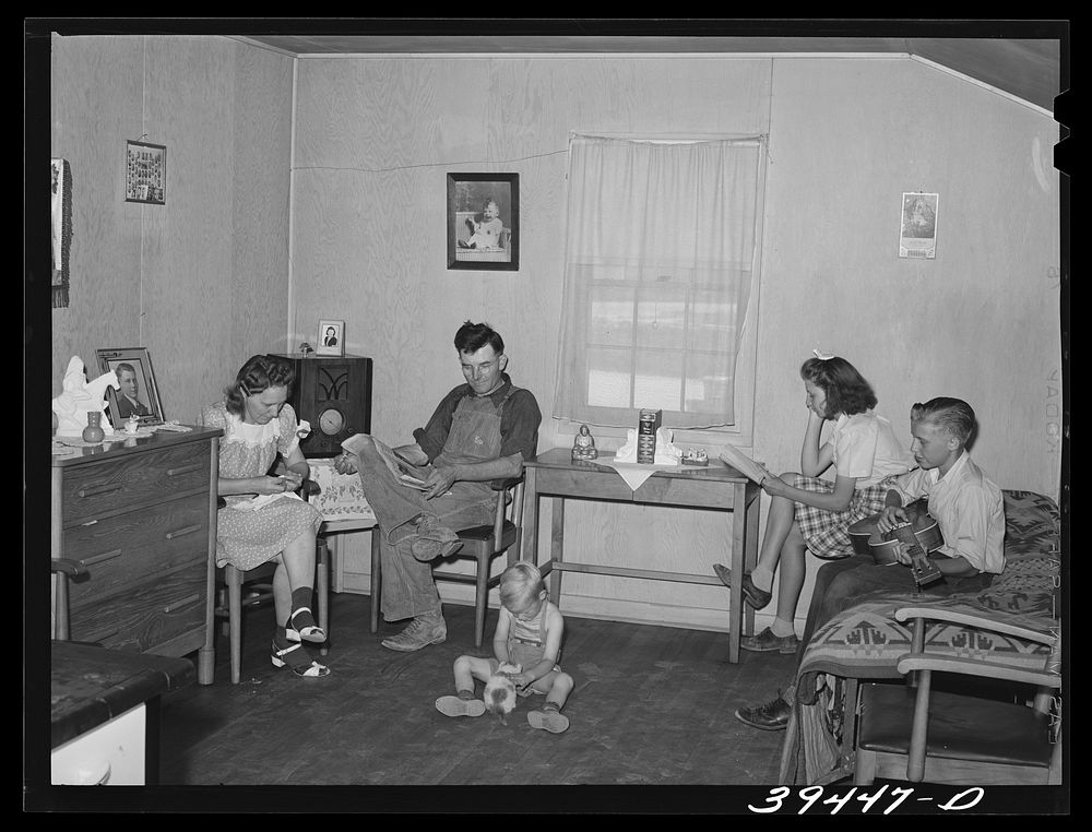 Farm worker and his family in their cottage at the FSA (Farm Security Administration) labor camp. Caldwell, Idaho. He is one…