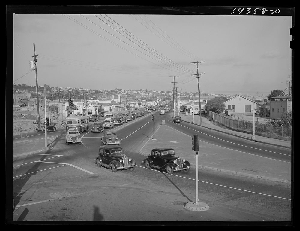[Untitled photo, possibly related to: Traffic moving out of town on main highway when Consolidated Aircrafts changes shift…