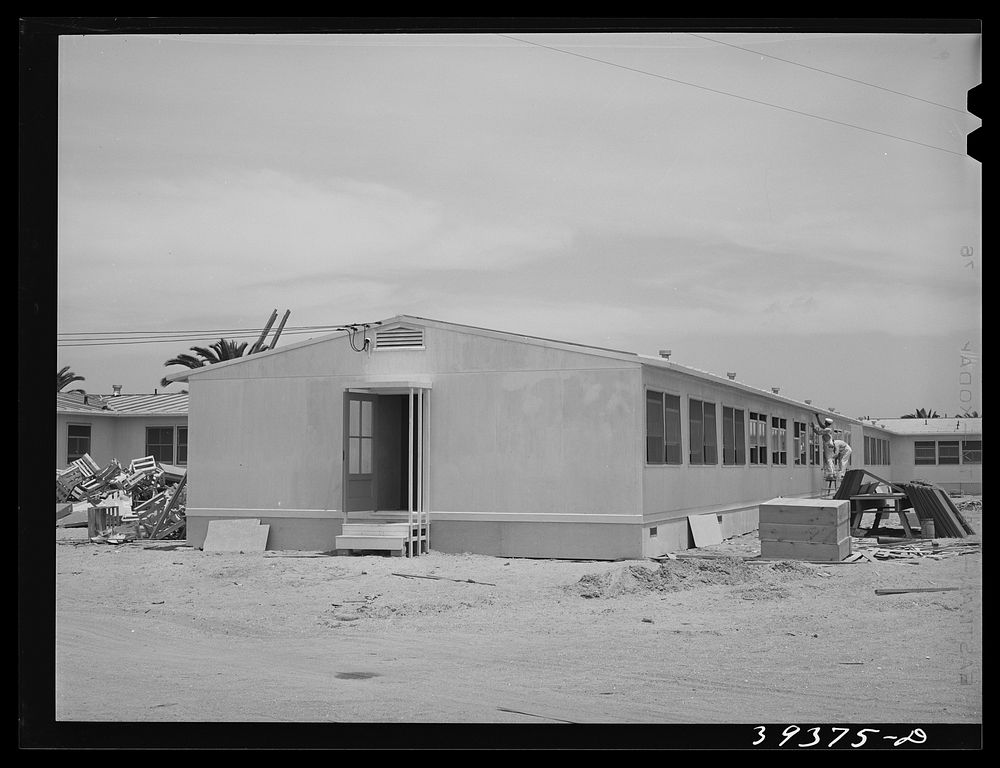 Painters working on dormitories at the FSA (Farm Security Administration) camp for defense workers. Dormitories are being…