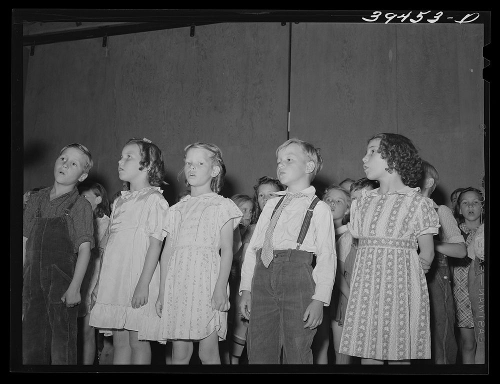Schoolchildren in program which was given at the end of the school term. FSA (Farm Security Administration) labor camp.…