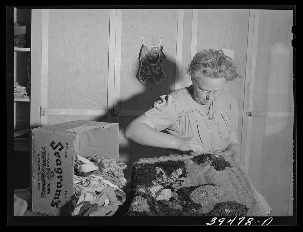Farm worker's wife making hooked rug in sewing class. A WPA (Work Projects Administration) project at the FSA (Farm Security…