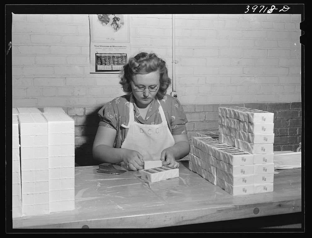 Wrapping quarter pounds of butter at the Dairymen's Cooperative Creamery. Caldwell, Canyon County, Idaho. During 1940…