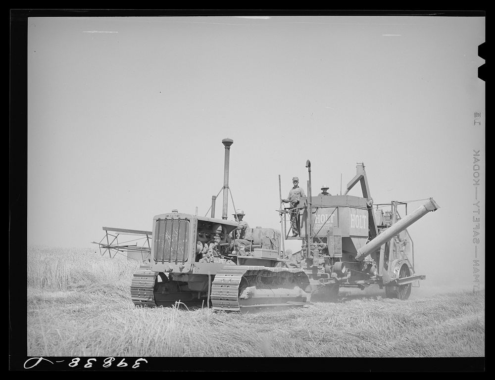 Caterpillar tractor and combine in wheat field on Eureka Flats. Walla Walla County, Washington by Russell Lee