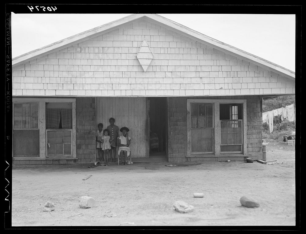 Old garage used for a dwelling by a  family. Outskirts of Graham, North Carolina. Sourced from the Library of Congress.