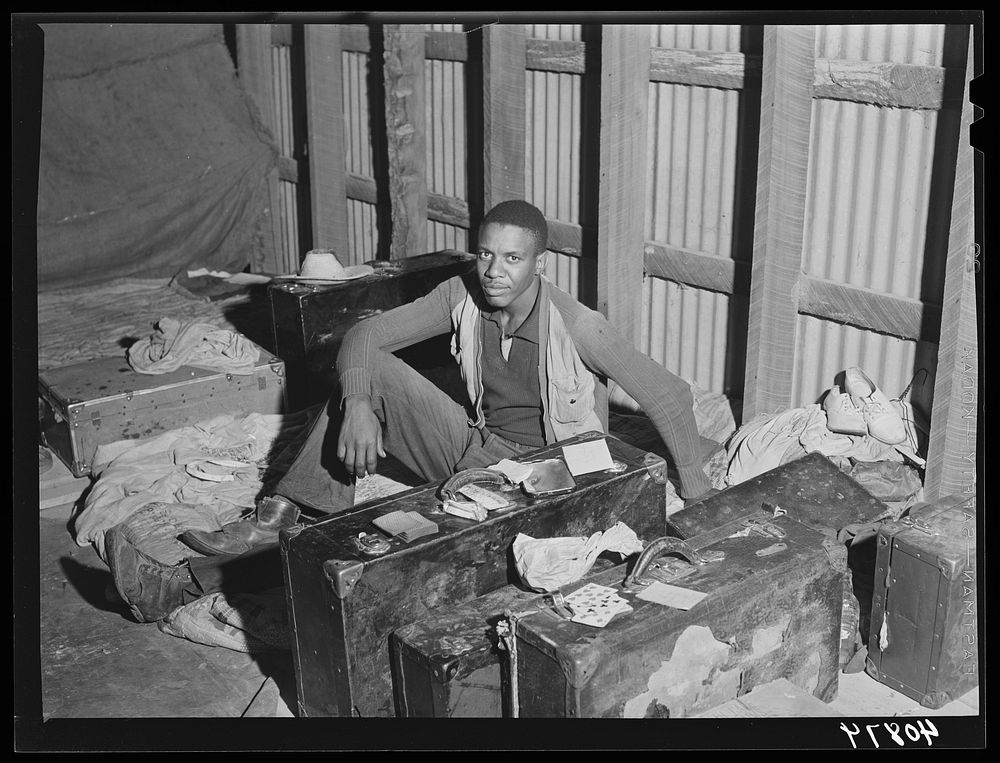 In the attic of the grading station at Belcross, North Carolina, are living quarters for some of the migratory agricultural…