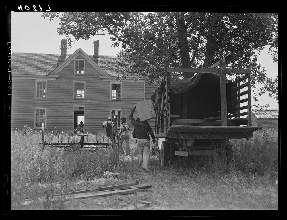 Florida migratory agricultural workers arrive at their new home near Onley, Virginia. There is no store at this place and…
