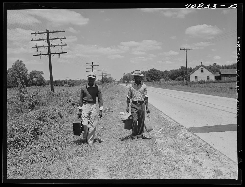 Migratory agricultural workers on Route 27 trying to "hitch" north with the potato season. North Carolina. Sourced from the…