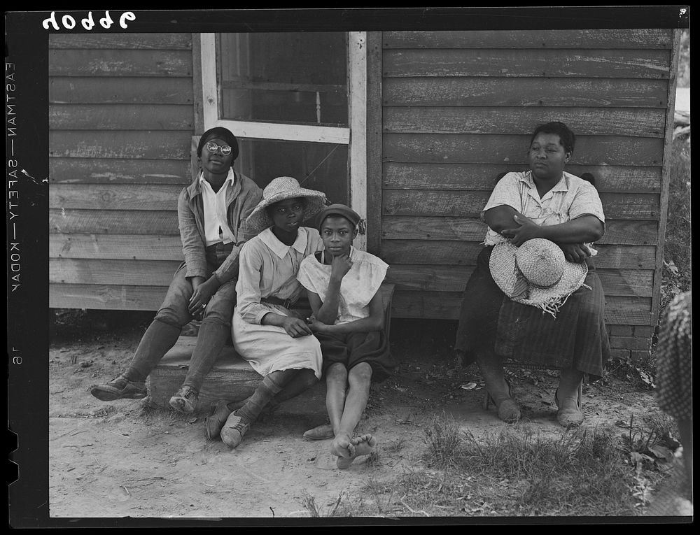 A group of Maryland tomato pickers resting during lunch period. Westover, Maryland. Sourced from the Library of Congress.