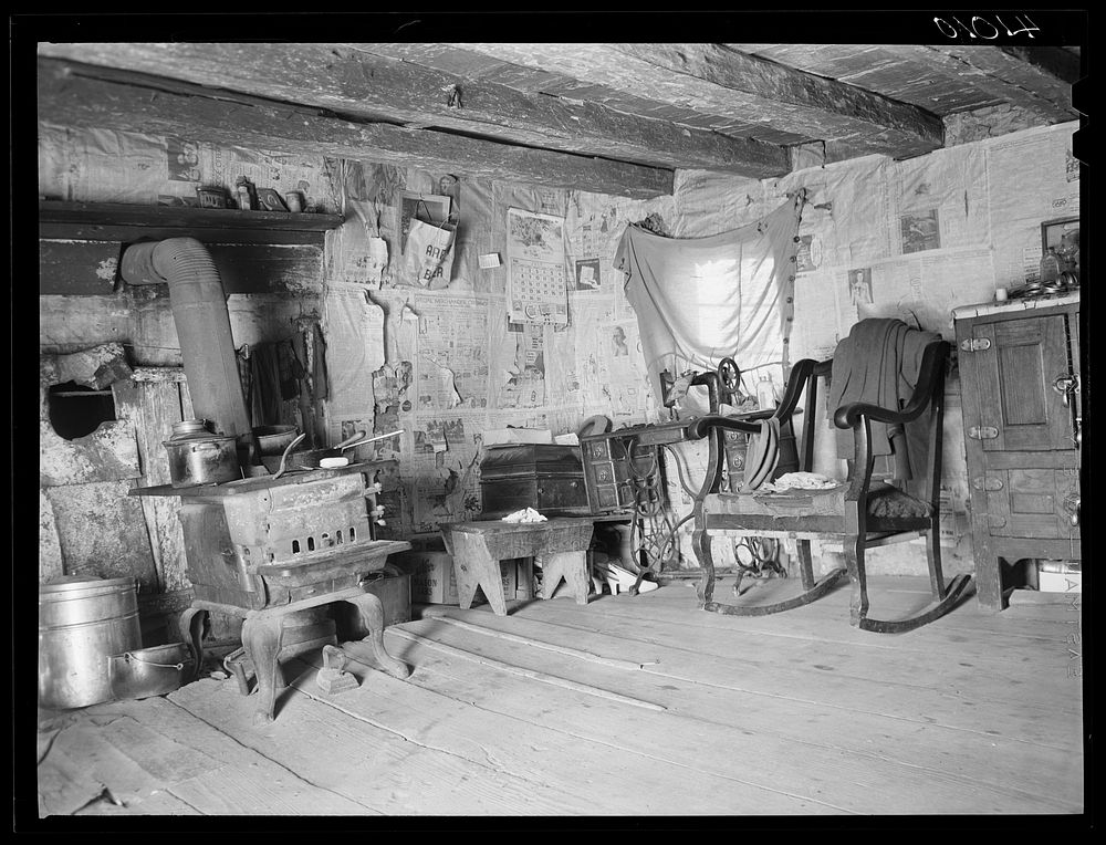 An old log cabin occupied by the family of FSA (Farm Security Administration) client George W. Green. A new house is being…
