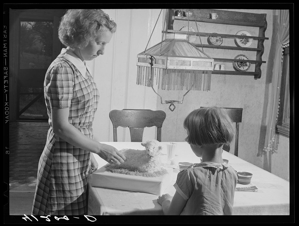 [Untitled photo, possibly related to: Two of the Reitz children putting the finishing touches on "lamb cake" made by Mrs.…