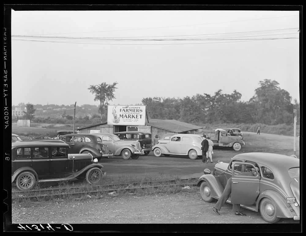 Customers' cars parked in front of Tri-County Farmers Co-op Market in Du Bois, Pennsylvania. Sourced from the Library of…