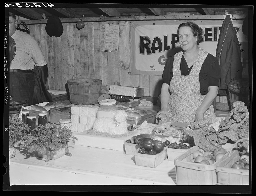 Mrs. Ralph Reitz by her booth at the Tri-County Farmers Co-op market at Du Bois, Pennsylvania. Sourced from the Library of…