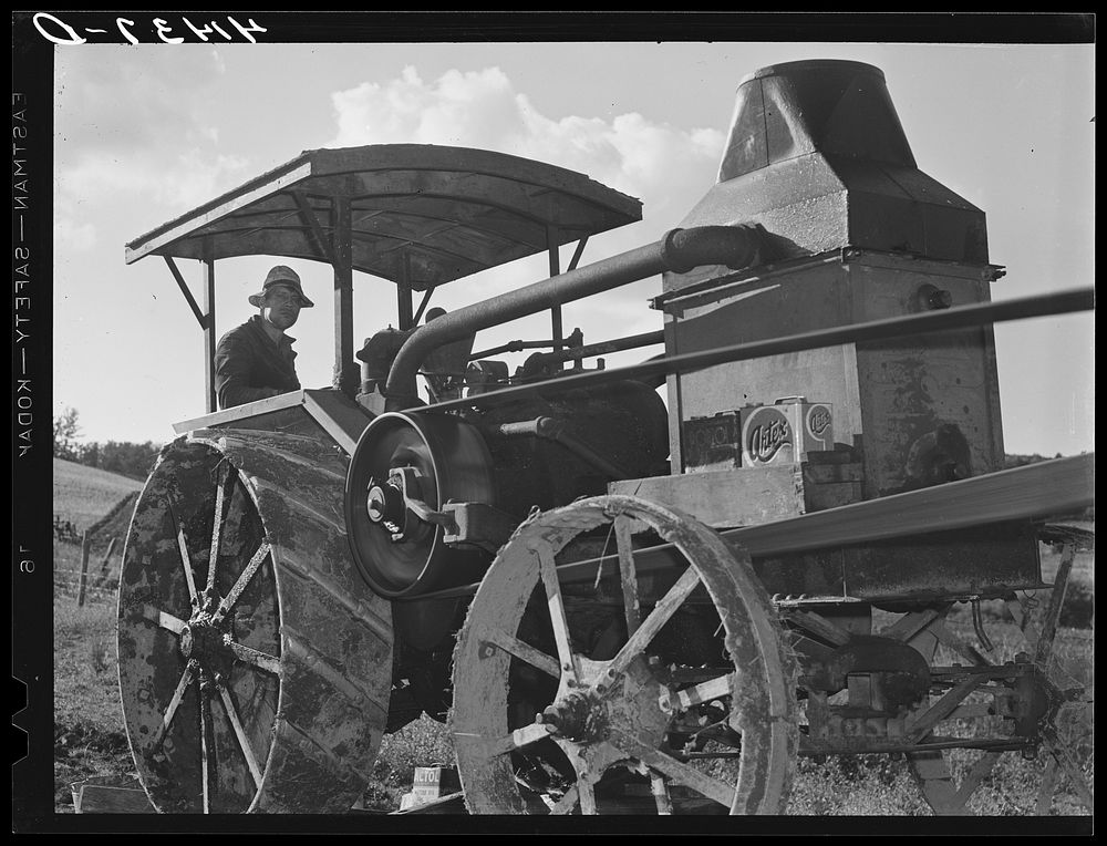 Tractor engine used to operate threshing machine at the farm of Alfred Shaffner, in submarginal farm area of Sugar Hill…